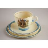A Clarice Cliff Newport Pottery Elizabeth II Coronation teacup, saucer and side plate, with