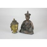 A brass Buddha head, together with a Chinese bronze figure of a seated deity