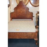 A Queen Anne style walnut single bed with shaped arch headboard, footboard, irons and upholstered