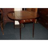 A mahogany Pembroke table with two drop flaps above a single drawer and opposing dummy drawer, on