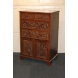 A carved chest of two short over two long drawers above a cupboard with twin panel doors enclosing a