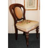 A Victorian walnut dining chair with oval padded pierced back and tapestry seat, on carved