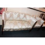 An Edwardian inlaid mahogany salon suite, upholstered in floral satin fabric, comprising couch,