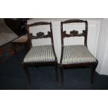 A pair of Regency mahogany dining chairs with rope twist and scroll carved backs, drop-in