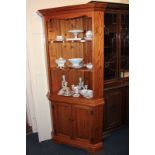 A Younger Furniture pine corner cabinet, the top with two shelves, on base with cupboards and plinth