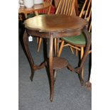 A circular occasional table with serpentine top and under shelf, on slender cabriole legs, 61cm