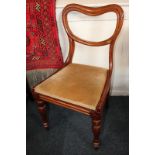 A near matching set of four Victorian mahogany dining chairs with kidney shaped backs and drop-in