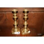 Late 19th early 20th cent. Brassware: Candle holders with pushers - a pair. 10ins.