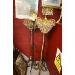 20th cent. Lighting: Floor standing two tier chandelier, brass column supported on a tripod base - a