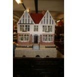Toys: 20th cent. Dolls house over three stories with a large box of furniture.