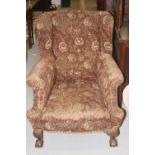 Early 20 cent. Mahogany, framed wing back chair on ball and claw feet.