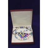 Jewellery: Cultivated pearl necklace with interspersed blue crystals and matching earrings in a box,