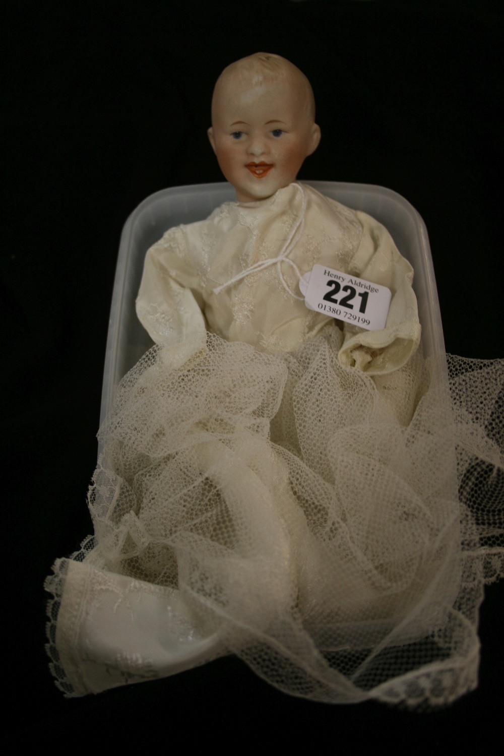 Dolls: Gebruder Heubach boy/baby doll Bisque head, composition body (a/f.) with silk and lace dress.