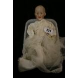 Dolls: Gebruder Heubach boy/baby doll Bisque head, composition body (a/f.) with silk and lace dress.