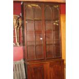 19th cent. Mahogany bookcase on cupboard, 12 glazed panels, 4 with Gothic arch above to closed