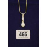 Jewellery: A fine cord chain yellow metal, marked 375 with a suspended pendant with 3 graduated