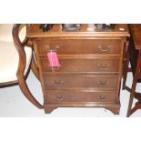 20th cent. Reproduction mahogany four drawer chest on bracket supports.