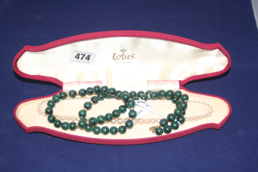 Jewellery: Lotus simulated pearls, necklace (boxed) plus a green bead necklace with yellow metal