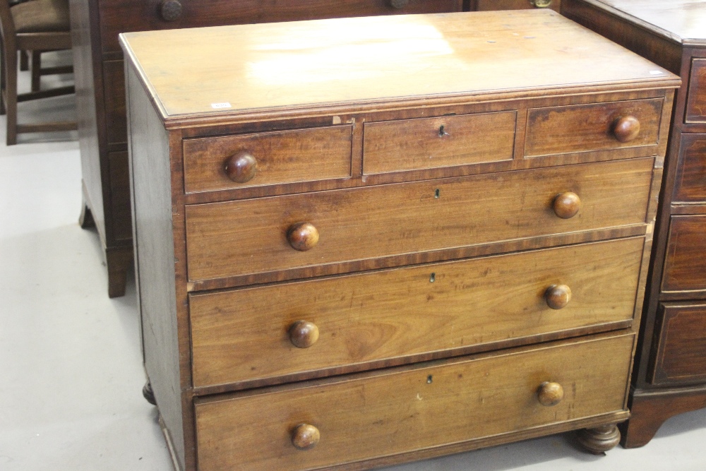 19th cent. Mahogany 3 over 3 chest of drawers on bun feet.