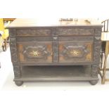 18th cent. Oak heavily carved cupboard 2 drawers over twin drawers & brushing slides decorated