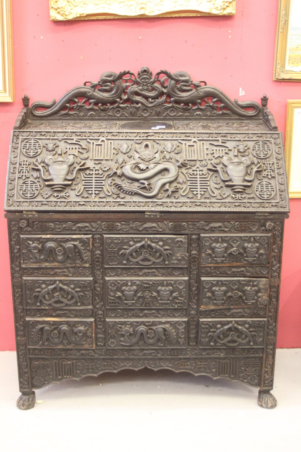 Far East: Pre-war 20th cent. heavily carved ebonised bureau the drop flap reveals a fitted