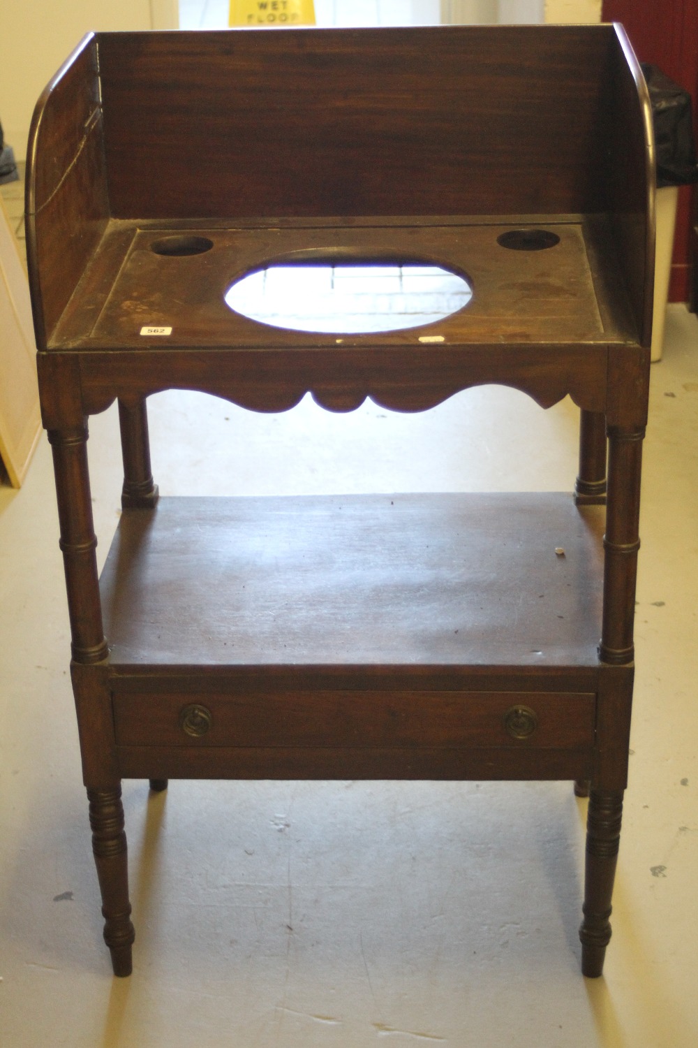 Early 19th cent. Mahogany washstand on turned tapering supports.