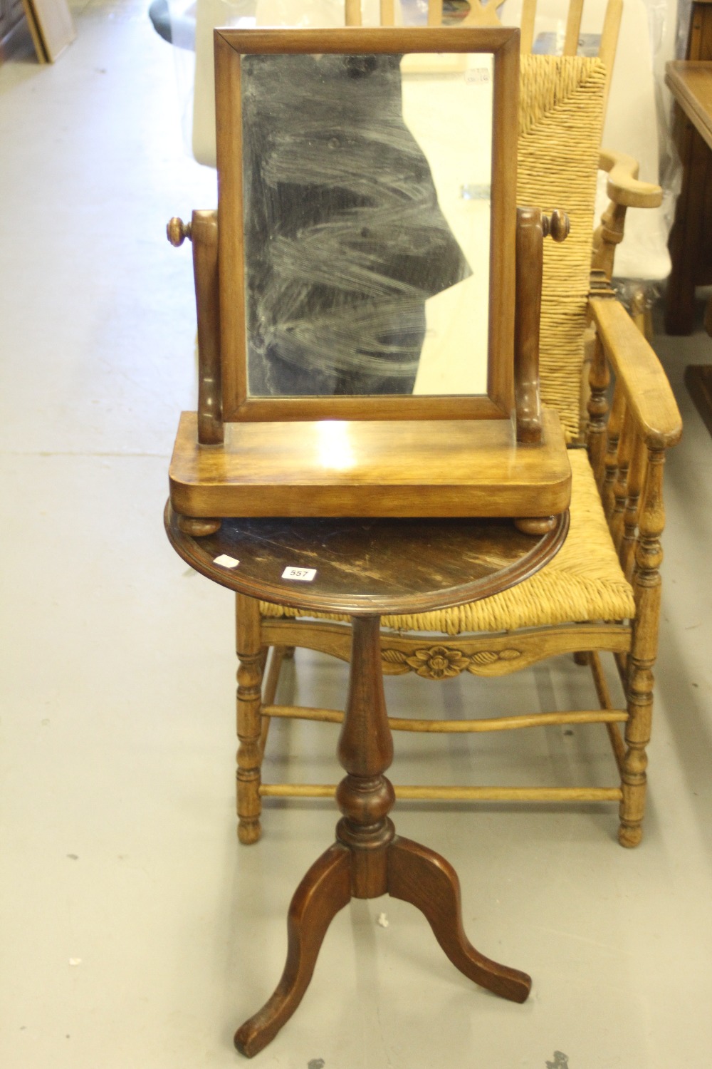 19th cent. Mahogany carved top occasional table and an oak dressing table mirror on stand (2).