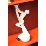 20th cent. Ceramics: Art deco style table lamp, a nude model holding a torch with a white glass