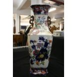 Oriental: 19th/20th cent. Geometric vase decorated in a blue and red palette with flowers and an