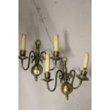 20th cent. Light Fittings: Brass two branch wall sconce in the form of candles, a pair, in need of