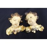 19th cent. Treen: Continental carved cherub heads, painted & gilded - a pair. Height 6¼ins.