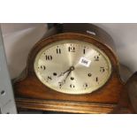 Clocks: Oak cased German mantel clock, Westminster chime, and oval dial.