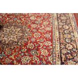 Carpet: 20th cent. Meshed carpet, red ground, strong blues, greens, yellow with ivory corners and