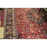 Carpets: 20th cent. Meshed carpet, red ground floral design strong in blues, greens, browns