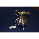 English Georgian Silver: Betrothal jug, ornate handle, variegated top and 3 cast paw feet.