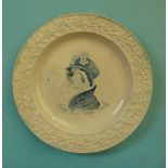 Queen Caroline: a pottery nursery plate with floral and foliate moulded border printed in blue