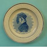 Queen Caroline: a pottery nursery plate with moulded border printed in blue with a named half-length