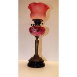 A CRANBERRY OIL LAMP WITH BRASS CORINTHIAN COLUMN,