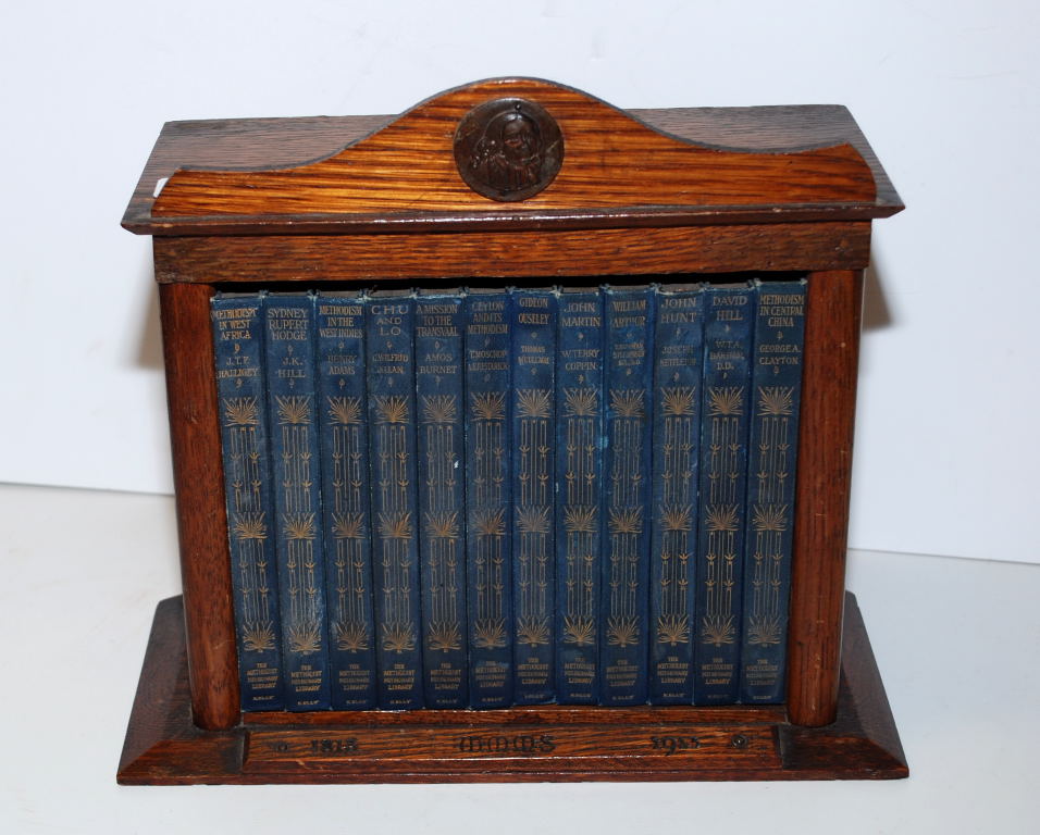 SMALL ARTS AND CRAFT STYLE BOOK CASE AND CONTENTS, 12 VOLS THE METHODIST MISSIONARY LIBRARY,