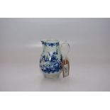 A WORCESTER BLUE AND WHITE JUG OF FLUTED FORM, PAINTED WITH FLOWERS AND ROCKS,