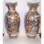 A PAIR OF JAPANESE VASES CIRCA 1900 HEAVILY DECORATED WITH WARRIORS, SUBJECT TO RESTORATION,