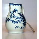 A WORCESTER BLUE AND WHITE CREAM JUG WITH LOOP HANDLE PAINTED WITH FLOWERS,