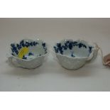 A PAIR OF WORCESTER BLUE AND WHITE BUTTER BOATS PAINTED WITH FLOWERS (ONE WITH FIRING CRACK BOTH