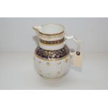 A WORCESTER MASKED JUG DECORATED WITH UNDER GLAZED BLUE BANDS AND GILDING,