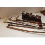 A SELECTION OF SIX RIDING CROPS ALONG WITH CASED HUNTING FLASK