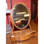 A GEORGE II MAHOGANY SERPENTINE DRESSING MIRROR WITH OVAL FRAME