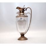 A GLASS SILVER MOUNTED CLARET JUG,