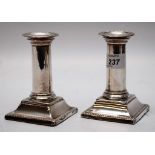 A PAIR OF SILVER SQUAT CANDLESTICKS (RUBBED MARKS) LONDON ASSAY,