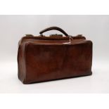 A VINTAGE LEATHER GLADSTONE TYPE DOCTOR'S BAG BEARING ORIGINAL LABEL,