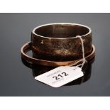 A SILVER BANGLE OF SCROLLED FOLIATE DESIGN,